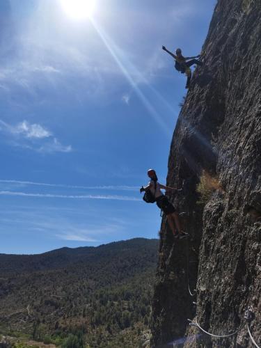 a person taking a picture of a rock climber at CASA RURAL CELIA con Escape Room in Ayna