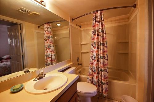 a bathroom with a sink and a shower curtain at 2306 Ocean Pointe in Tavernier