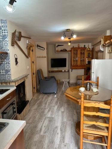 a kitchen and living room of a tiny house at Casa Angel in Cazorla