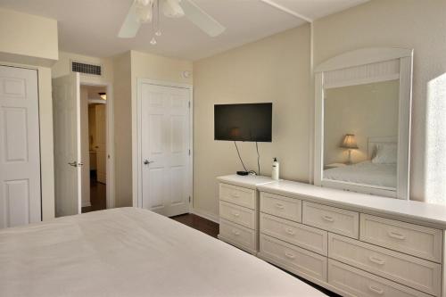 a bedroom with a bed and a large mirror at B 405 Moon Bay in Key Largo