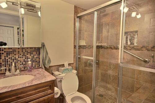 a bathroom with a shower and a toilet and a sink at B 405 Moon Bay in Key Largo