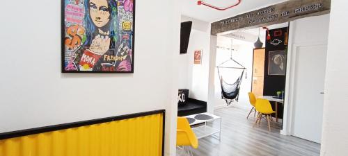 a living room with yellow chairs and a yellow wall at XOXO - Salinas in Ponferrada