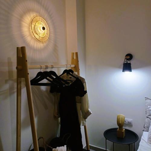 a dressing room with a dress hanging on a rack at nisaki rooms & apartments in Methana