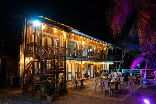 a restaurant at night with people sitting at tables at Hotel Katamaran in Capurganá