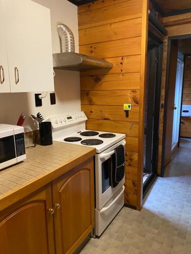 a kitchen with a stove top oven next to a counter at Dakune Chill - The Chalet in Ohakune