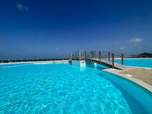a swimming pool in the middle of the ocean at Studio Epoustouflante Vue Mer St Martin in Saint Martin