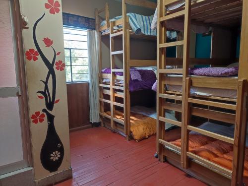 a room with four bunk beds in a room at Casa de Sila in Cusco