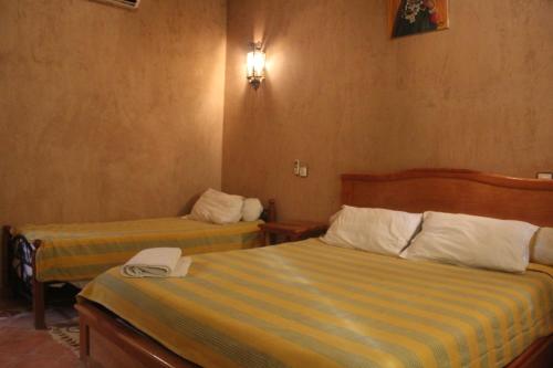 a hotel room with two beds in a room at Dar Lamrani in Rissani