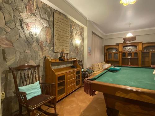 a room with a pool table and a stone wall at Bahga villa in Alexandria