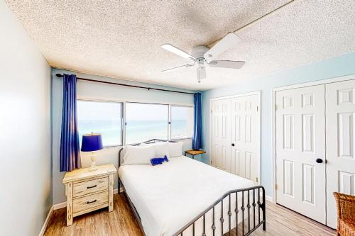 a bedroom with a bed and a ceiling fan at Pinnacle Port A-516 in Panama City Beach