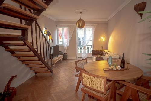 a living room with a wooden table and a staircase at Villa Lobos - By Y Concept in Setúbal
