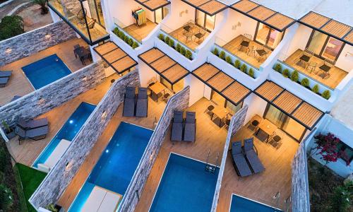 an overhead view of a house with blue pools at Aelia Suites in Agios Nikolaos