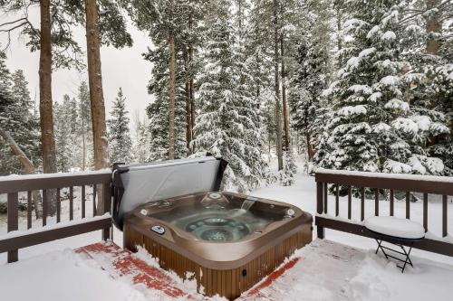 a hot tub on a deck in the snow at Hot Tub and Ski Shuttle Forested Breckenridge Home! in Breckenridge