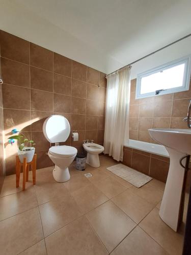 a bathroom with a toilet and a sink at Ventanas de la Patagonia 2 in Esquel