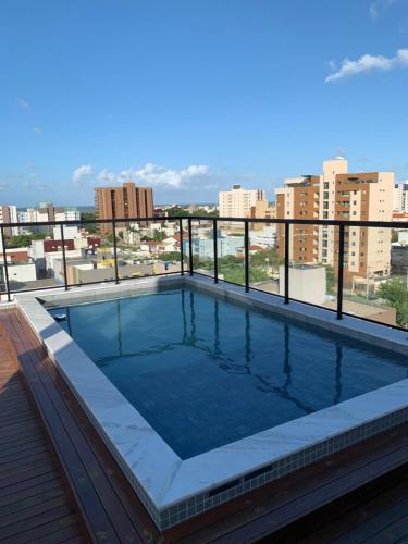 a swimming pool on the roof of a building at Pérola do Bessa in João Pessoa