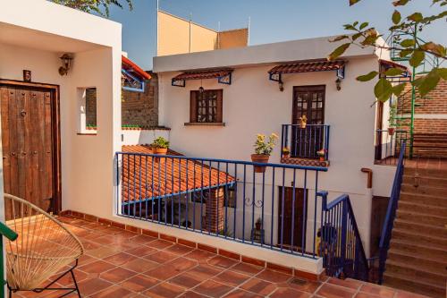 a balcony of a house with a blue fence at Abadia de San Pedro in Guadalajara