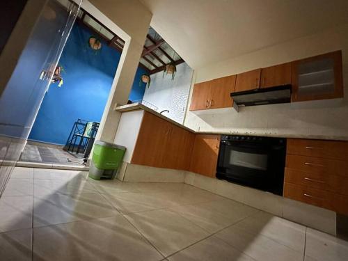 an empty kitchen with a green trash can in it at Casa Pavón in Morelia