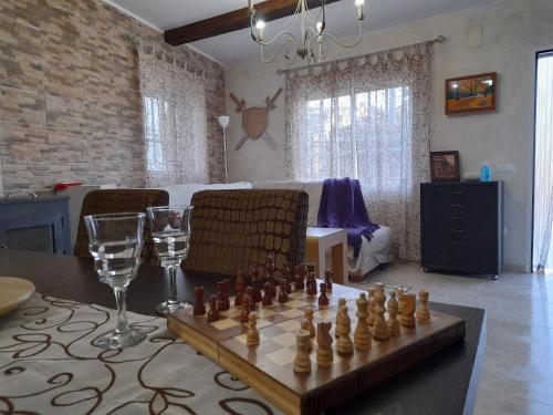 a living room with a chess board and wine glasses at Casa Rural del Saz in Yeste