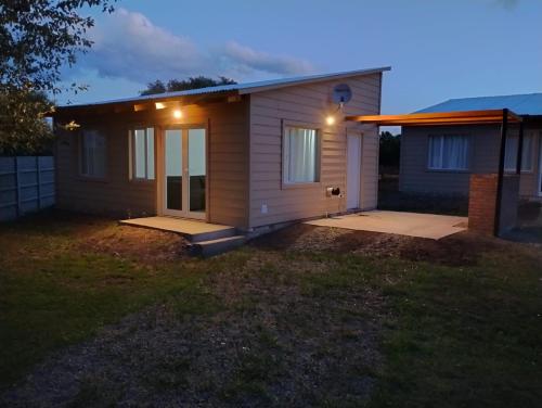 uma pequena casa com luzes na frente em Cabañas Huella Andina em La Aldea