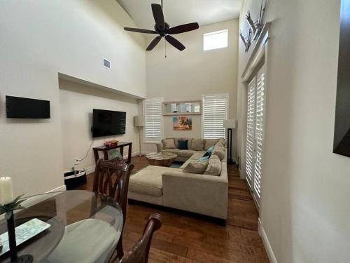 a living room with a couch and a ceiling fan at Mojito Breeze Getaway sleeps 11 and 2 full bathroom islamorada tavanier dock in Tavernier