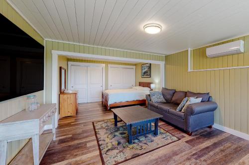 a living room with a couch and a bed at Mill Pond Suite in East Boothbay