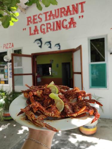 a person holding up a plate of food at Freedom Shores "La Gringa" Hotel - Universally Designed in Isla Aguada