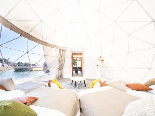 a room with four beds and a pool at GLAMP ELEMENT(グランエレメント） in Maibara