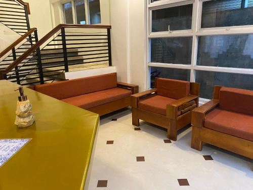 a living room with benches and chairs and a staircase at Lighthouse View Boutique Hotel in Caticlan