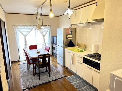 a kitchen with a table and a dining room at KASUMI-an Sora in Shimo-tatsuda