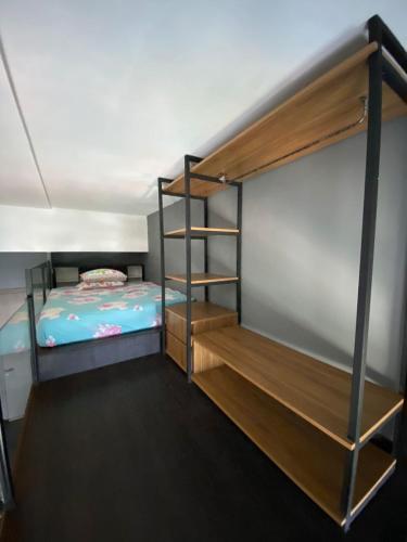 a bedroom with a bunk bed and a ladder at Apartemen bintaro icon loft industrial in Pondokaren