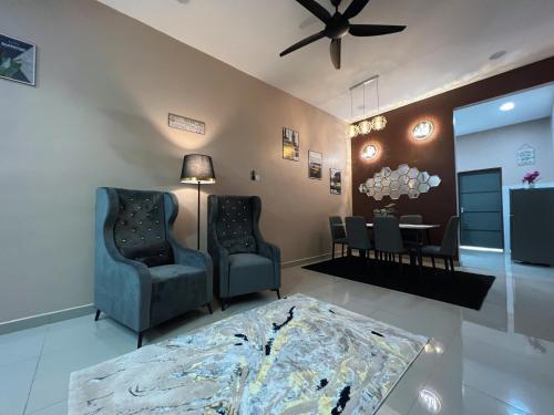 a living room with two chairs and a table at Kayangan Homestay Kuantan MUSL!M Only in Kuantan