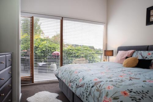 a bedroom with a bed and a large window at Gables Bend Spa Villa in Daylesford