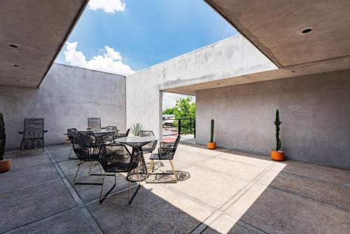 a dining room with a table and chairs on a patio at Santa Ma la Ribera Apartments by VH in Mexico City