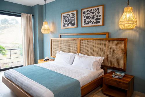 a bedroom with a large bed and a window at Jama Campay - Homes Resort & Spa in Jama