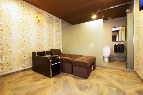 a bathroom with a couch and a toilet at Star Romantic in Batu Pahat