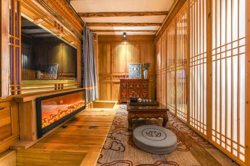 a living room with a fireplace in the middle at The blue mountains on the moon in Shangri-La