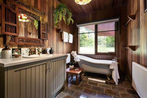 a bathroom with a tub and a sink at Gumtree Spring in Daylesford