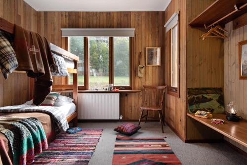 a bedroom with a bed and a desk and a window at Gumtree Spring in Daylesford