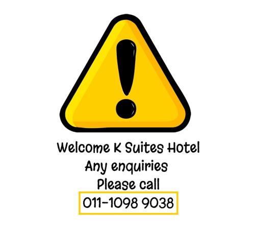 a yellow warning sign for a virus quarantine area at K SUITES HOTEL in Chabang Tiga