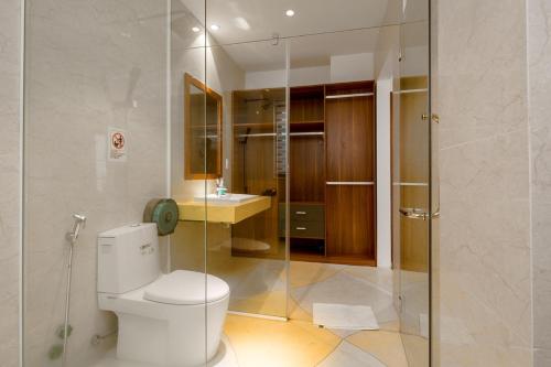 a bathroom with a toilet and a glass shower at Stunning Da Nang Beach Villa in Da Nang