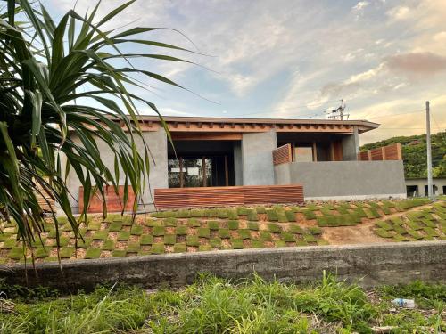 a house with a garden in front of it at Amami 与庵 in Amami