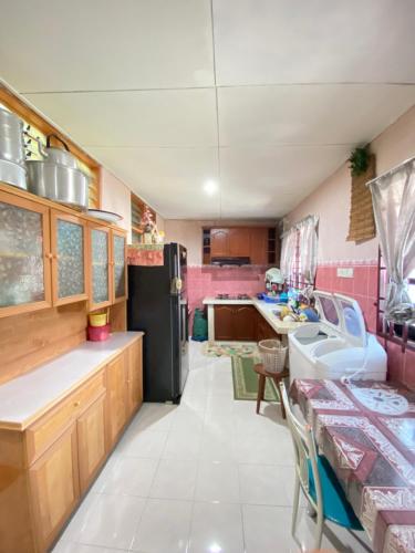 a kitchen with a sink and a refrigerator at The Z Homestay in Jitra