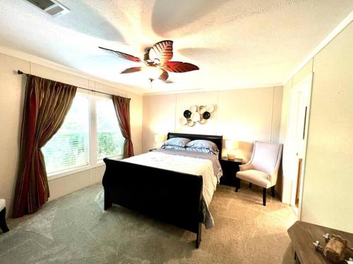 a bedroom with a bed and a ceiling fan at Pink Flamingo House in Cocoa