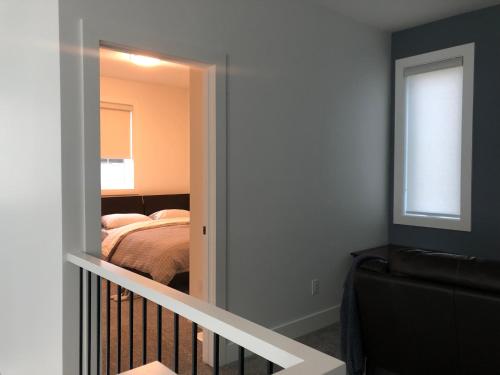 a bedroom with a door leading to a bed at Room in a New Guest House in Fort Saskatchewan