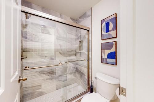 a bathroom with a toilet and a glass shower at Canyon Oasis- Canyon View #3214 in Tucson