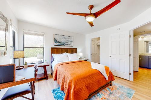 a bedroom with a bed and a desk and a ceiling fan at Canyon Oasis- Canyon View #3214 in Tucson