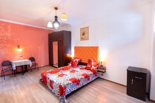 a bedroom with a bed and a table in a room at Homestay in Tbilisi center GM in Tbilisi City