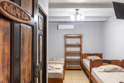 Zimmer mit 2 Etagenbetten und einer Leiter in der Unterkunft Hotel El Baquiano in Tamarindo