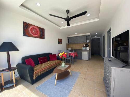 a living room with a couch and a table at Crystal Bay Tropical Residence in Koh Samui