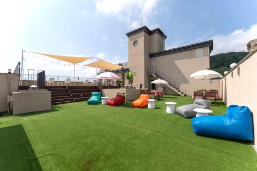 a lawn with colorful bean bags on it at Geoje Mongdol Beach H Avenue Hotel in Geoje 